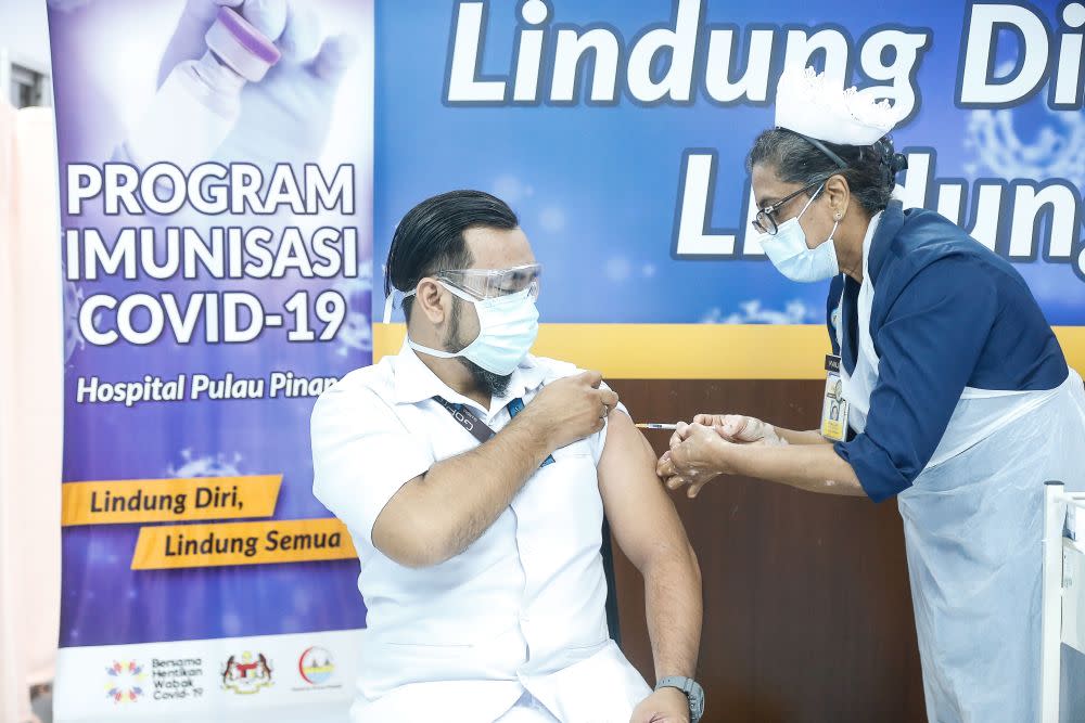 A medical worker receives his Covid-19 jab at the Penang General Hospital in George Town March 2, 2021. — Picture by Sayuti Zainudin