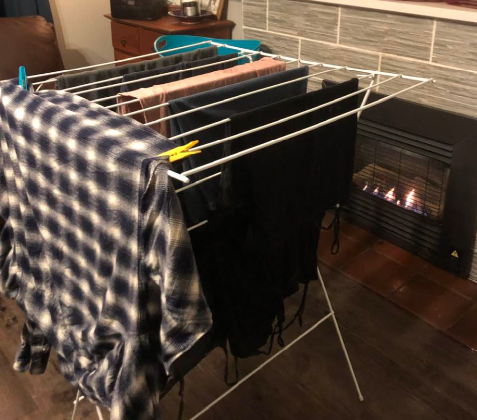 A flannel shirt on a drying rack to trap hot air from a heater