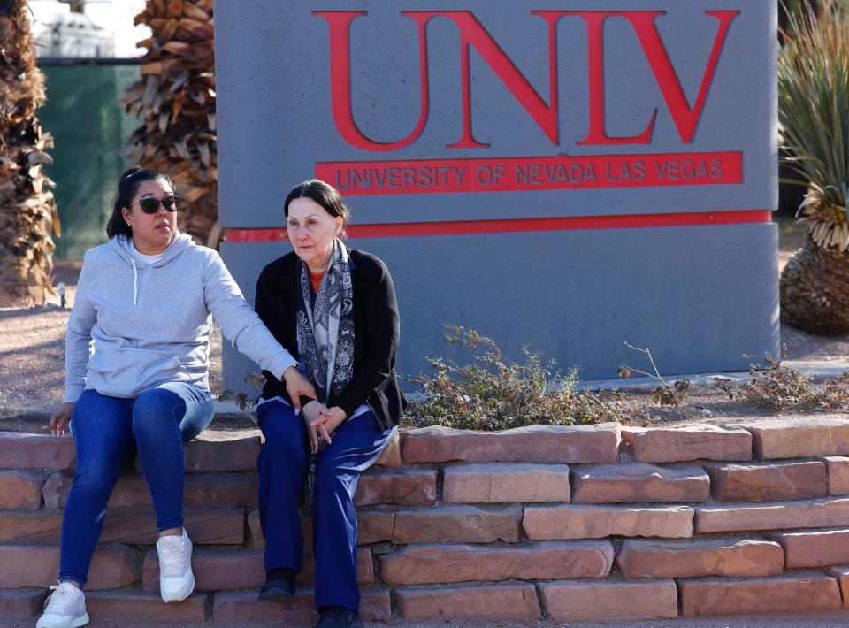 Two women are pictured sitting after a shooting on the University of Nevada, Las Vegas, campus.