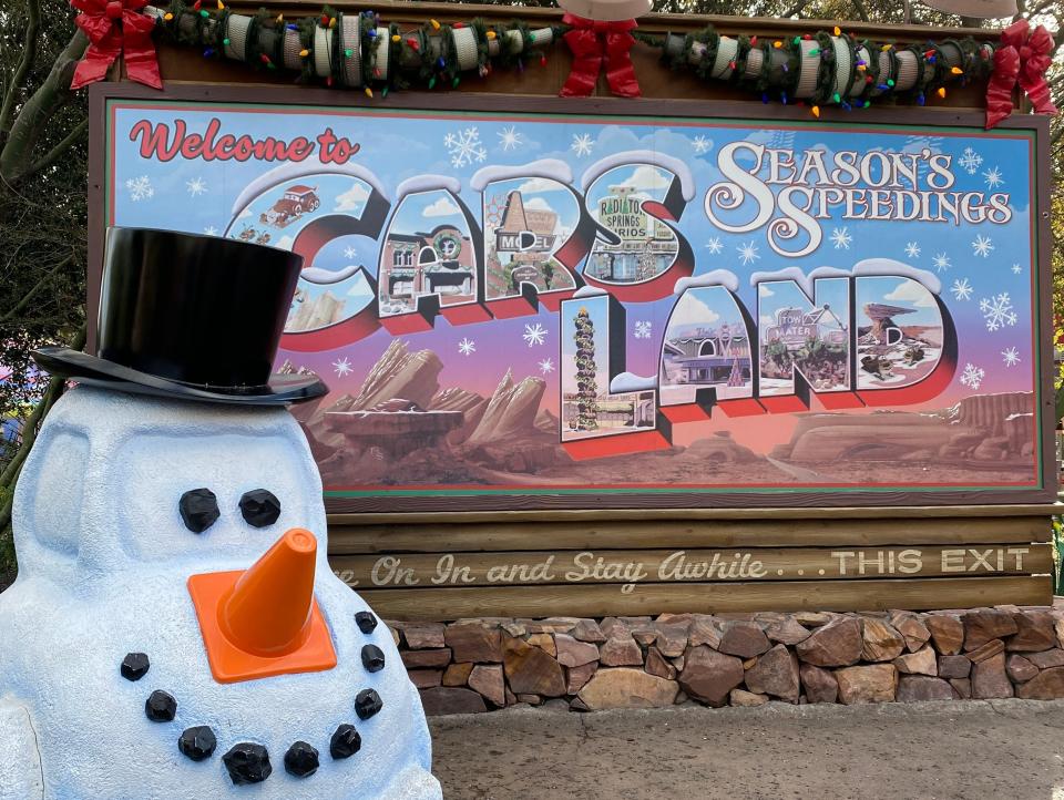 holiday decorations on the carsland sign at disneyland