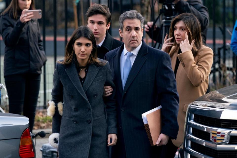 Michael Cohen arrive at federal court for sentencing with his children, Samantha and Jake, and wife Laura Shusterman (AP)
