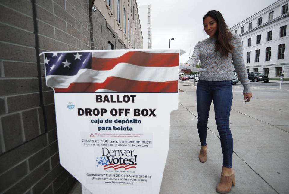 Rosa Amaya of Denver drops off drop off ballots at the Denver Electoral Commission Tuesday, May 7, 2019, in Denver. Voters could make Denver the first U.S. city to decriminalize the use of psilocybin, the psychoactive substance in "magic mushrooms" if the measure passes. (AP Photo/David Zalubowski)