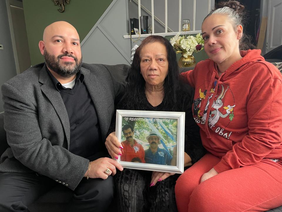Javier Quintana, Maria Quintana and Anabel Brown Quintana hold a photograph of Emilio Quintana, the father of Javier and Anabel and ex-husband of Maria. Emilio Quintana was a bodega owner who was killed in a robbery attempt May 15, 1991.