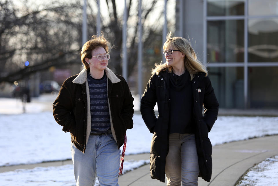 Eli Musselman, left, and his mother, JoEllen Musselman, walk through the campus at St. Joseph's University in Philadelphia on Monday, Feb. 14, 2022. Eli, a freshman, came out as transgender almost four years ago and has found support from friends and professors at the university. (AP Photo/Jessie Wardarski)