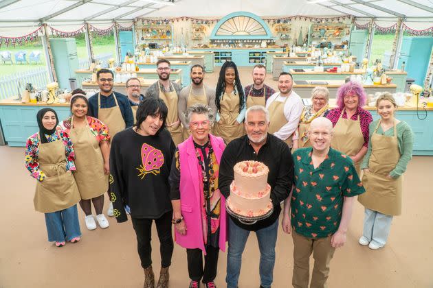 From left to right, host Noel Fielding, judges Prue Leith and Paul Hollywood and host Matt Lucas stand in front of the bakers of this season of 