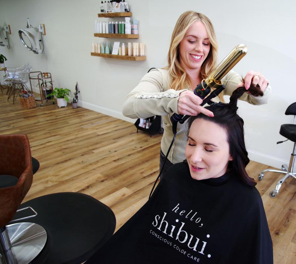 Arian Azevado works on the hair of her friend Chelsea Burr of Middleboro at Azevado's Boho Beauty Lounge at 1285 Belmont St. in Brockton on Monday, April 10, 2023.