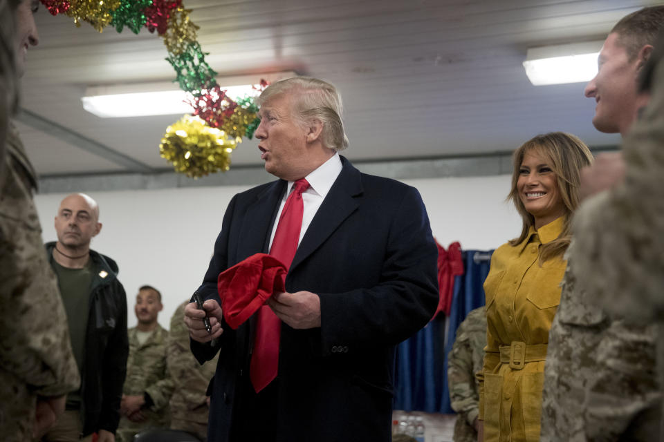 President Donald Trump and first lady Melania Trump visit with troops at a dining hall at Al Asad Air Base, Iraq, Wednesday, Dec. 26, 2018. In a surprise trip to Iraq, President Donald Trump on Wednesday defended his decision to withdraw U.S. forces from Syria where they have been helping battle Islamic State militants. (AP Photo/Andrew Harnik)