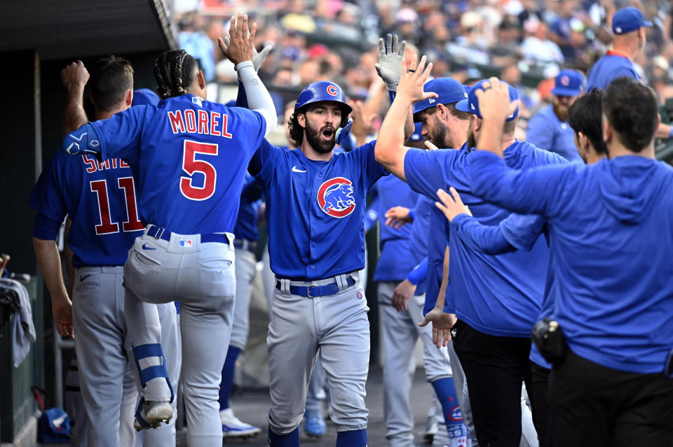 Chicago Cubs' Dansby Swanson, center, is congratulated by Christopher Morel (5) and others after a two-run home run off Detroit Tigers starting pitcher Reese Olson during the fourth inning of a baseball game, Tuesday, Aug. 22, 2023, in Detroit. (AP Photo/Jose Juarez)