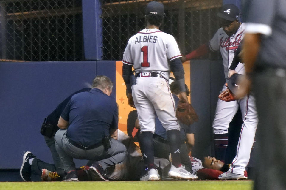 Atlanta Braves right fielder Ronald Acuna Jr., lies on the field after trying to make a catch on an inside-the-park home run hit by Miami Marlins' Jazz Chisholm Jr. during the fifth inning of a baseball game Saturday, July 10, 2021, in Miami. (AP Photo/Lynne Sladky)