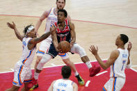 Washington Wizards guard Ish Smith, center, shoots over Oklahoma City Thunder guard Justin Robinson, clockwise from left, guard Svi Mykhailiuk, forward Darius Bazley, and guard Ty Jerome in the first half of an NBA basketball game, Monday, April 19, 2021, in Washington. (AP Photo/Patrick Semansky)