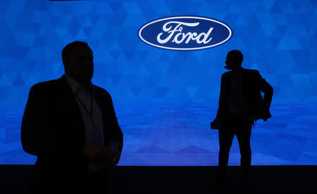 Workers prepare for the Ford Motor Company 2019 reveal at the North American International Auto Show in Detroit, Michigan, U.S., January 14, 2019. REUTERS/Jonathan Ernst/Files