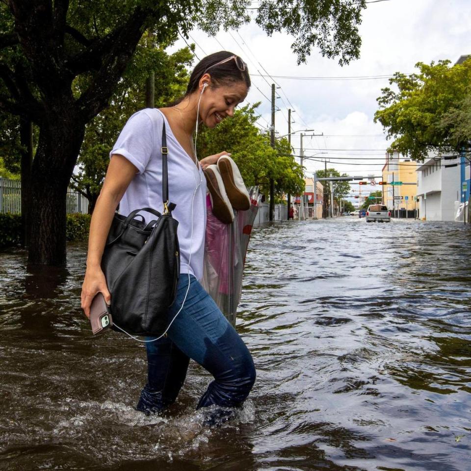 A pedestrian walks through floodwaters on Southwest Second Street in the Little Havana neighborhood of Miami, Florida, on Saturday, June 4, 2022.