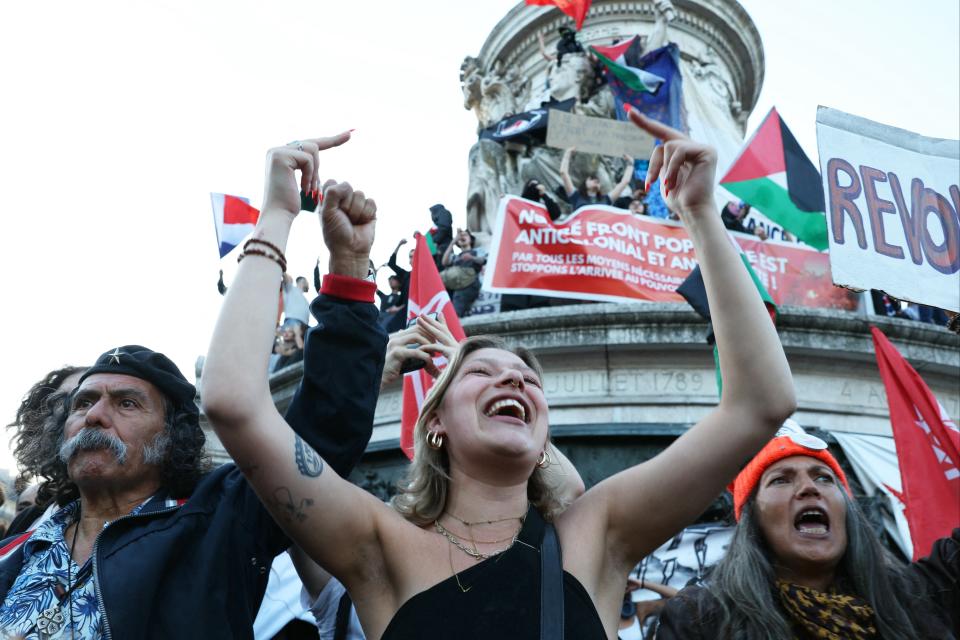 People attend a gathering for the election night following the second round results of France's legislative election at Republique Square in Paris (AFP via Getty Images)