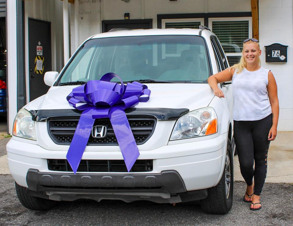Brittney Schuit is pictured with the Honda Pilot she was able to acquire through Working Wheels.