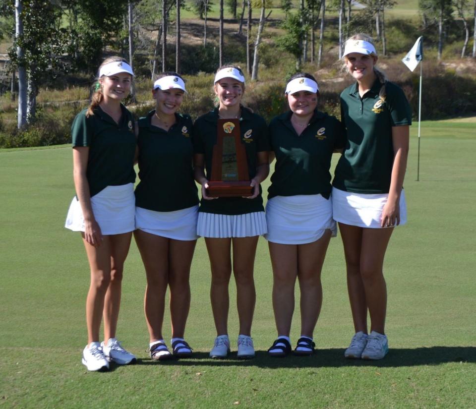 The Pensacola Catholic girls golf team celebrates after winning the District 1-1A title on Monday, Oct. 23, 2023 at Eagle Springs Golf Course in Defuniak Springs.
