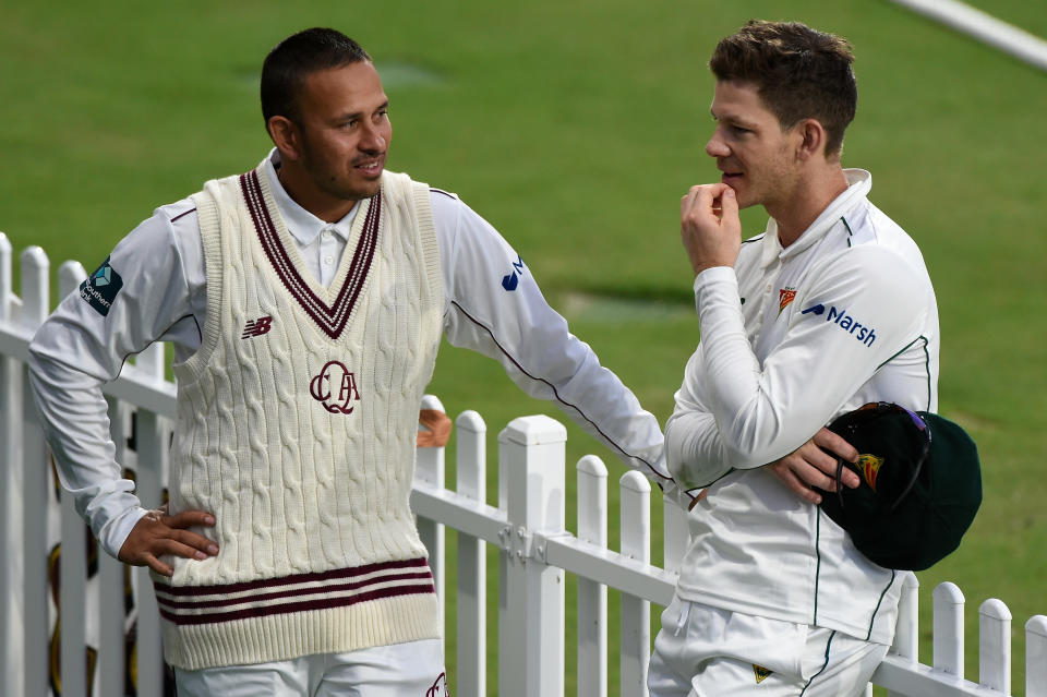 Tim Paine, pictured here speaking to Usman Khawaja after the opening day of Tasmania's Sheffield Shield match against Queensland.