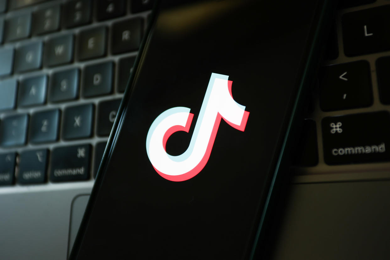 A laptop keyboard and TikTok logo displayed on a phone screen are seen in this illustration photo taken in Krakow, Poland on March 17, 2023. (Photo by Jakub Porzycki/NurPhoto via Getty Images)