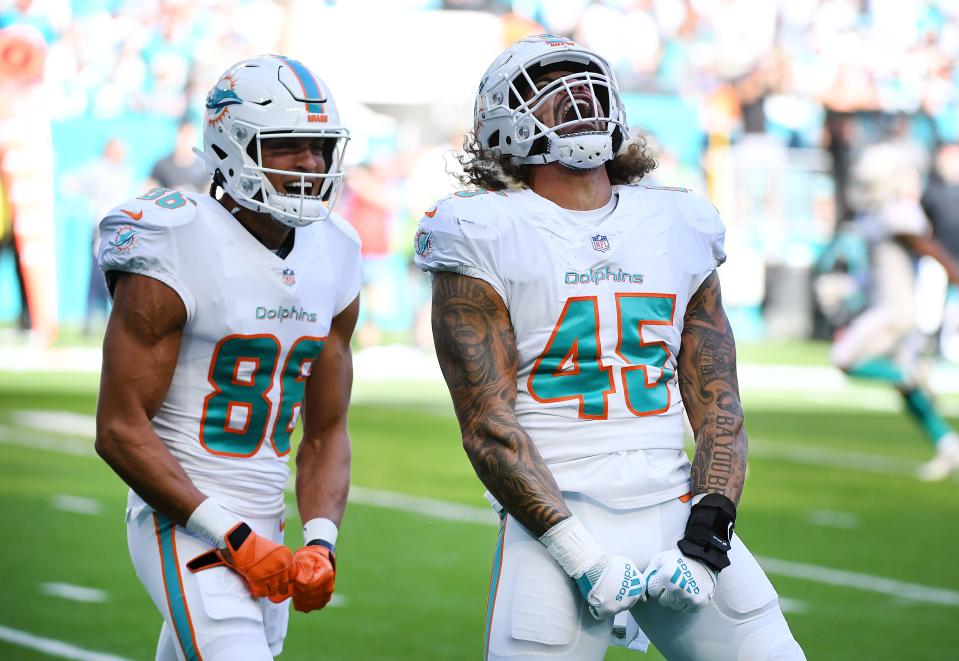 Duke Riley #45 of the Miami Dolphins celebrates after blocking a punt that was returned for a touchdown during the first quarter against the Carolina Panthers at Hard Rock Stadium on November 28, 2021 in Miami Gardens, Florida.