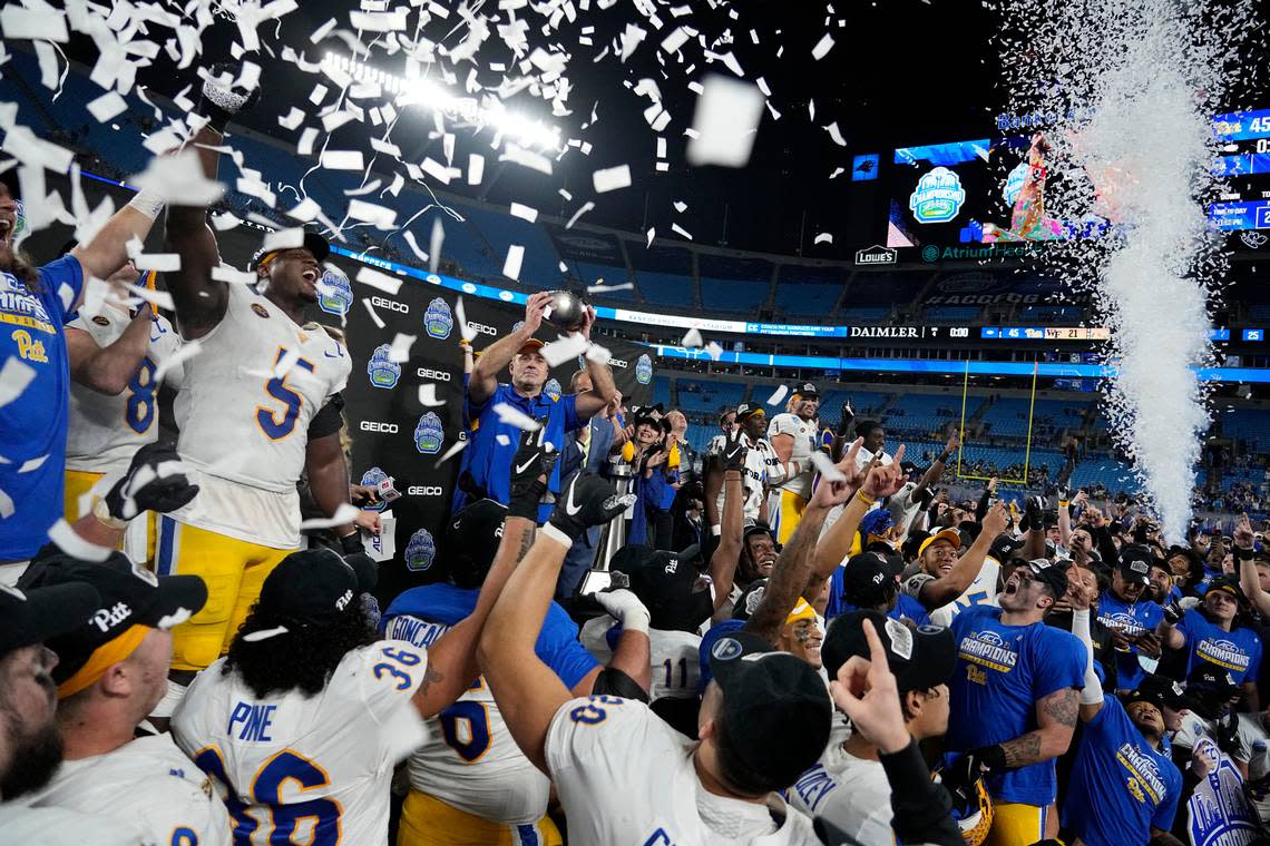 Pittsburgh head coach Pat Narduzzi celebrates with the trophy after their win against Wake Forest in the Atlantic Coast Conference championship NCAA college football game Saturday, Dec. 4, 2021, in Charlotte, N.C.