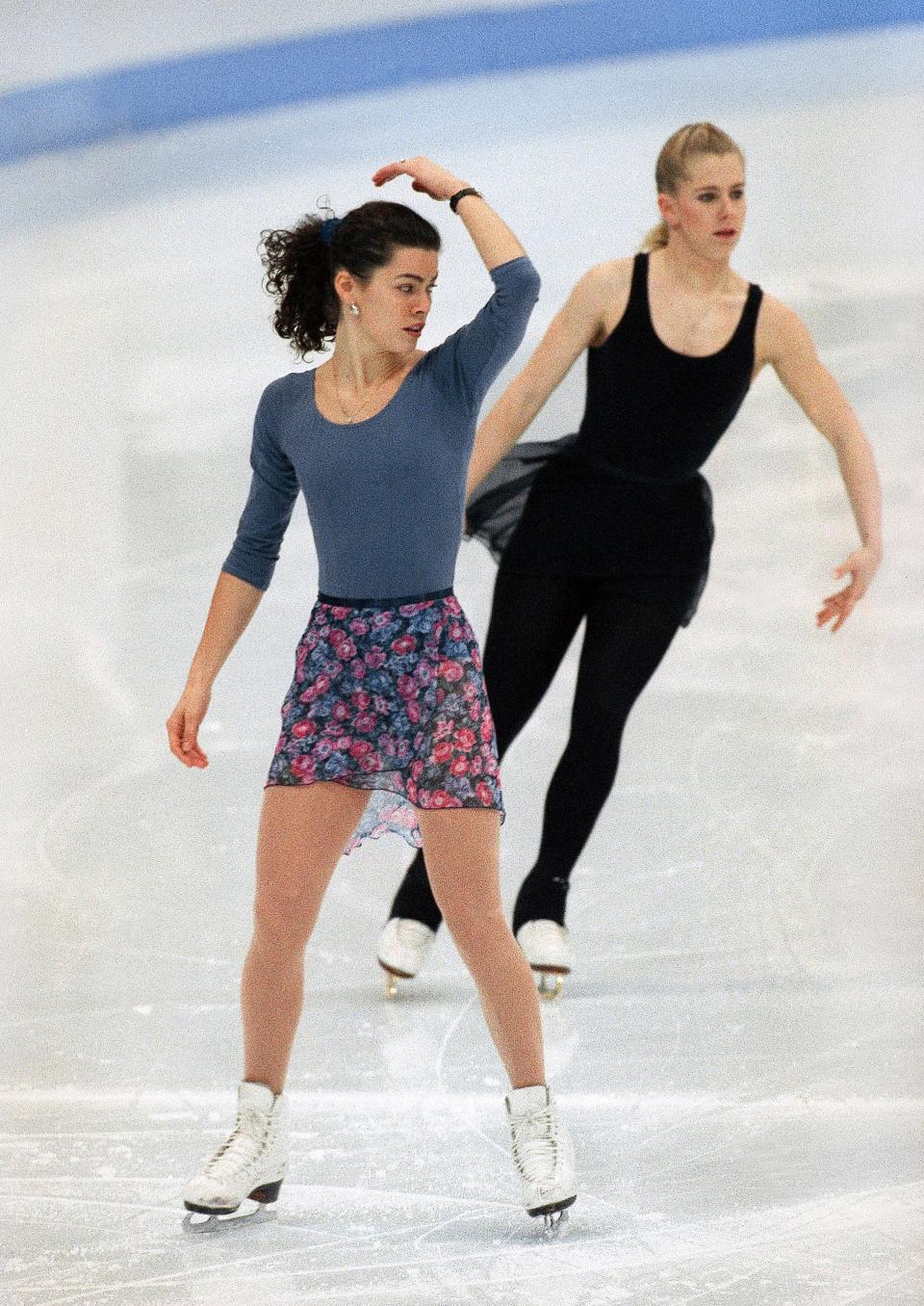 In this Feb. 22, 1994, file photo, American figure skaters Nancy Kerrigan, left, and Tonya Harding work out during an Olympic practice session at Hamar Olympic Amphitheater in Hamar, Norway. it's been nearly 20 years since Kerrigan was clubbed after practice in Detroit by a member of a bumbling goon squad hired by Harding's ex-husband with the hope of eliminating his former wife's top competition for the U.S. Olympic team. The assault led to a soap opera that practically created tabloid television journalism, taking what had for decades been a niche sport and putting it squarely into the media mainstream. By the time a recovered Kerrigan and a besieged Harding reached Lillehammer, their saga was front-page news and can't-miss TV. 