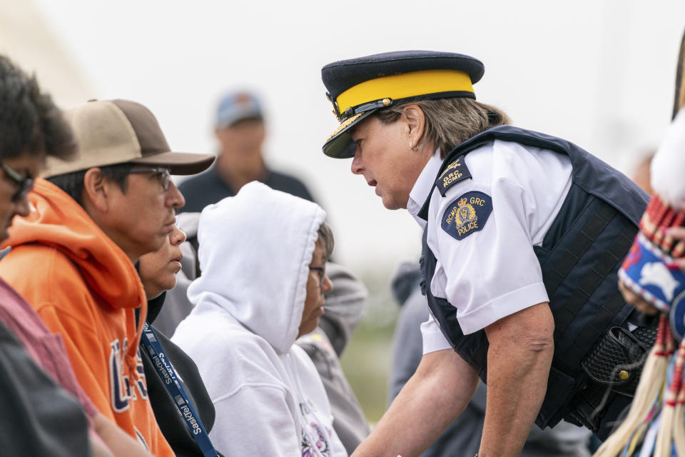 RCMP commissioner Brenda Lucki speaks with victims' family members during a Federation of Sovereign Indigenous Nations event where leaders provide statements about the mass stabbing incident that happened at James Smith Cree Nation and Weldon, Saskatchewan, Canada, at James Smith Cree Nation, Saskatchewan, Canada, on Thursday, Sept. 8, 2022. (Heywood Yu/The Canadian Press via AP)