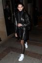 <p>The model stripped her high-fashion look back by wearing white trainers and a black leather trench coat out in Paris. </p>