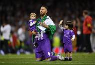 <p>Sergio Ramos of Real Madrid celebrates victory with his children after the UEFA Champions League Final between Juventus and Real Madrid at National Stadium of Wales on June 3, 2017 in Cardiff, Wales </p>