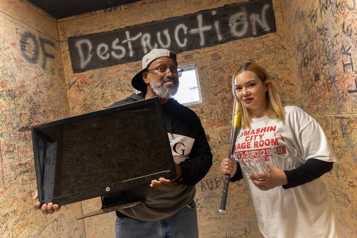 Delovi and Esther Canales, owners of Smashin City Rage Room in Toms River, a facility where patrons can safely project their hatred and rage onto breakable items.