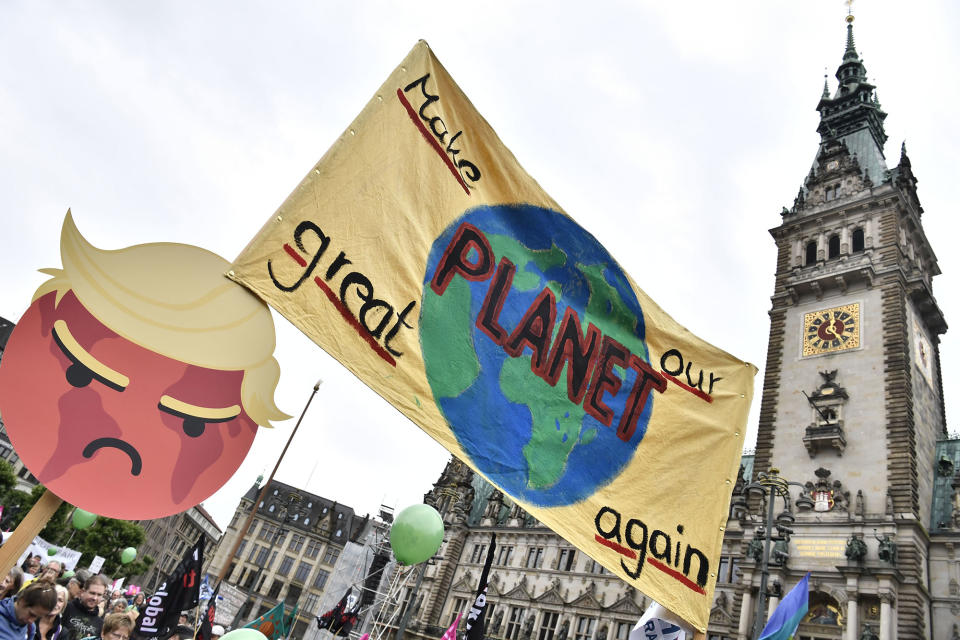 <p>A banner is lifted in front of the Hamburg city hall (Rathaus) during a demonstration called by several NGOs ahead of the G20 summit in Hamburg on July 2, 2017. (John MacDougall/AFP/Getty Images) </p>