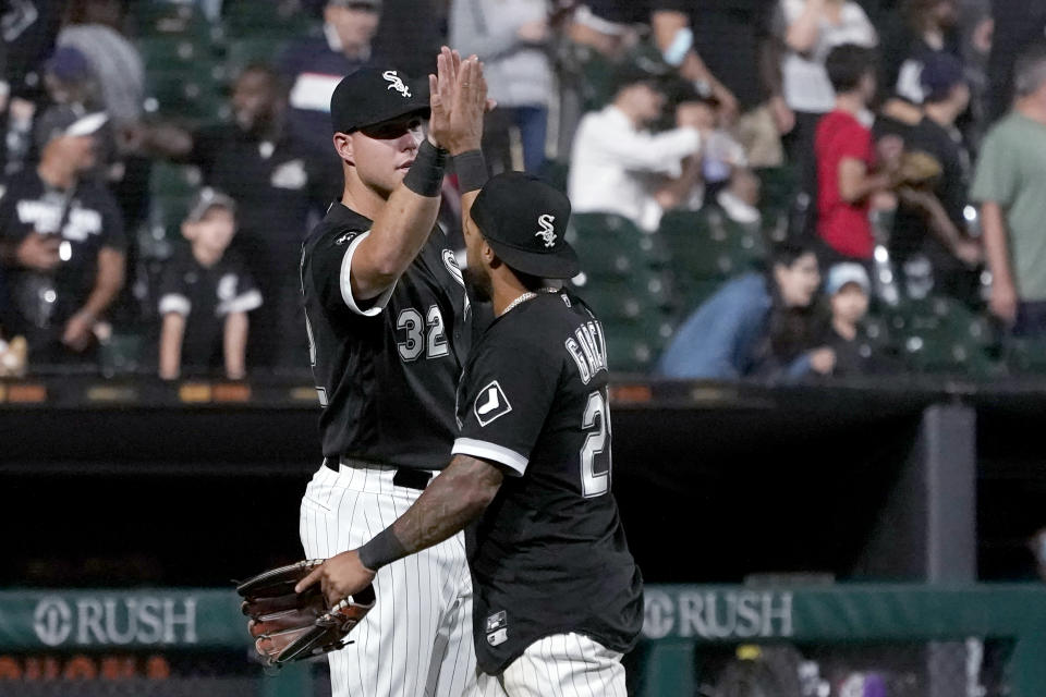 Chicago White Sox's Gavin Sheets (32) and Leury Garcia celebrate the team's 9-3 win over the Los Angeles Angels in a baseball game Tuesday, Sept. 14, 2021, in Chicago. (AP Photo/Charles Rex Arbogast)