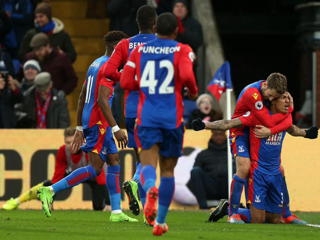 Patrick van Aanholt celebrates his goal for Palace: Getty