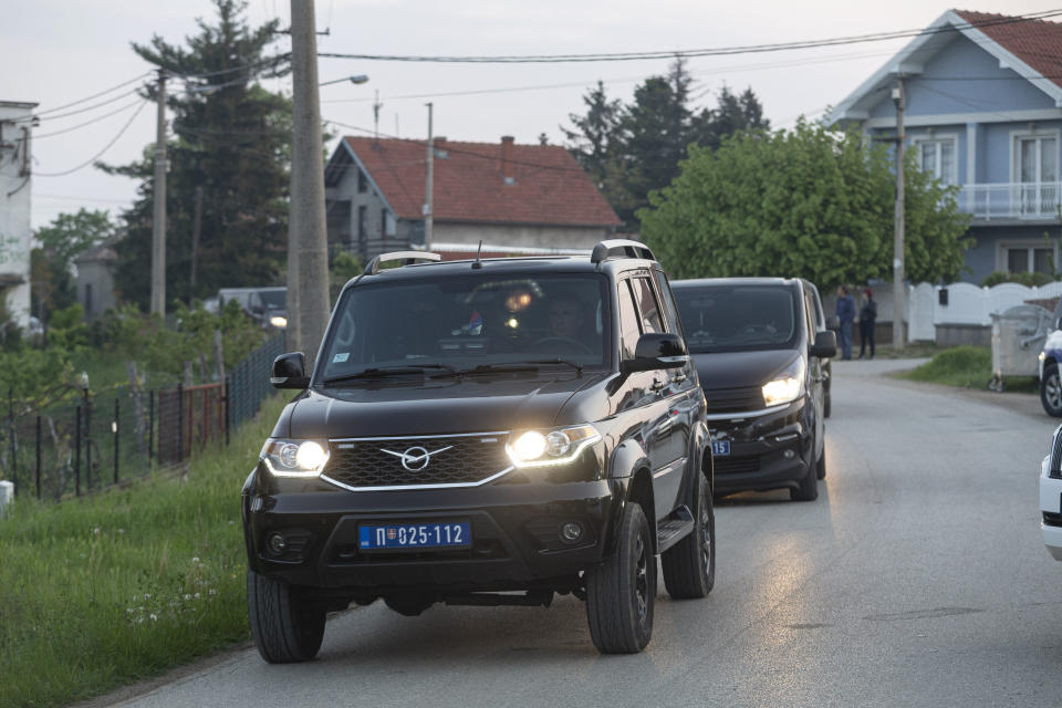 Police vehicles exit the village of Dubona, some 40 kilometers south of Belgrade, Serbia, Friday, May 5, 2023. A shooter killed multiple people and wounded more in a drive-by attack late Thursday in Serbia's second such mass killing in two days, state television reported. (AP Photo/Marko Drobnjakovic)