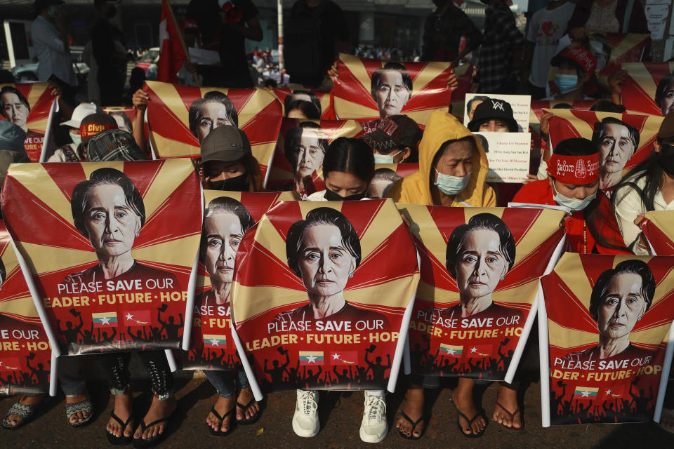 FILE - In this Feb. 20, 2021, file photo, anti-coup protesters hold identical posters with an image of deposed Myanmar leader Aung San Suu Kyi as they gather outside the Hledan Centre in Yangon, Myanmar. One hundred days since their takeover, Myanmar’s ruling generals maintain just the pretense of control over the country. There are fears the military takeover is turning Myanmar into a failed state. (AP Photo, File)