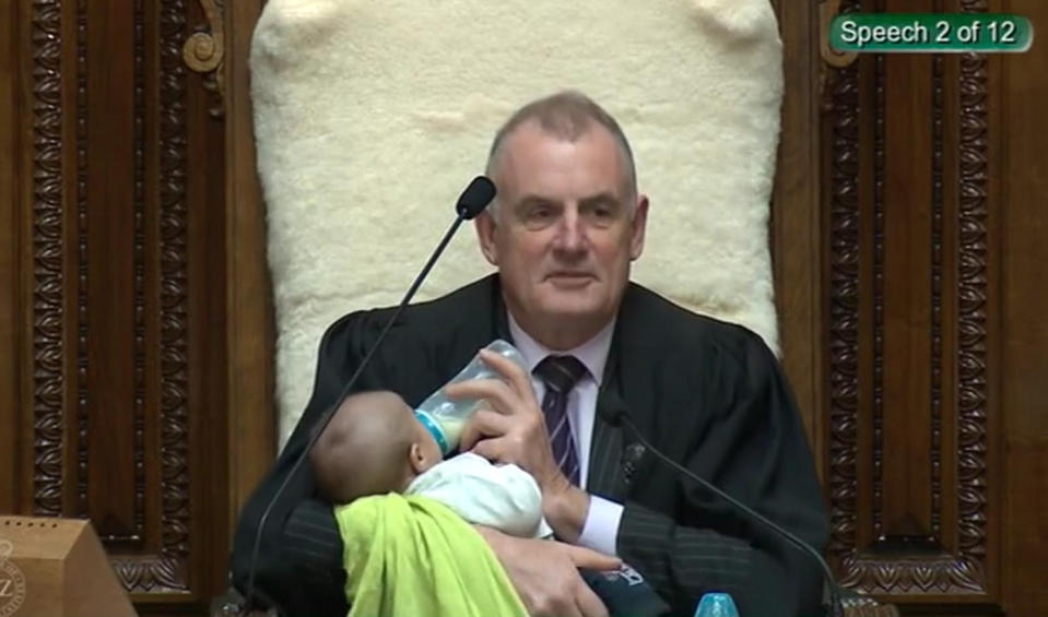 Trevor Mallard, Parlamentspräsident von Neuseeland, hält ein Baby während einer Debatte in der Nationalversammlung auf dem Arm und füttert es.  (Bild: Foto: New Zealand Parliament Tv And Ra/Press Association Images/dpa)