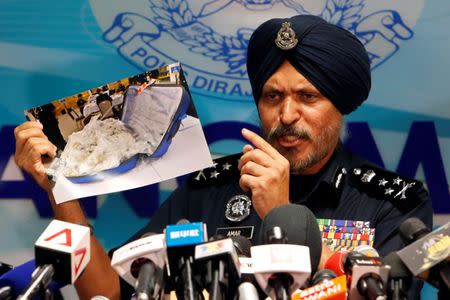 Amar Singh, head of Malaysia's Commercial Crime Investigation Department (CCID), displays a photo of items from a raid during a news conference in Kuala Lumpur, Malaysia June 27, 2018. REUTERS/Lai Seng Sin