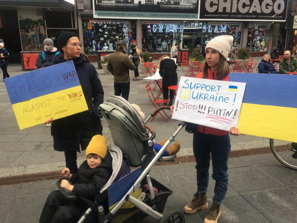 A Ukrainian family join the protests in Times Square on Thursday (Bevan Hurley/The Independent)