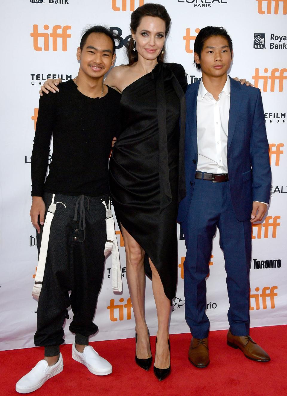 Thanks to their special behind-the-scenes status, Jolie's older sons got a special red-carpet pic with Mom, too! "They worked hard," <a href="http://people.com/celebrity/angelina-jolie-says-maddox-and-pax-worked-hard-on-set-as-she-jokes-kids-laughed-at-her-for-dressing-up/" rel="nofollow noopener" target="_blank" data-ylk="slk:she told Entetainment Tonight;elm:context_link;itc:0;sec:content-canvas" class="link ">she told <em>Entetainment Tonight</em></a> of Pax and Maddox.