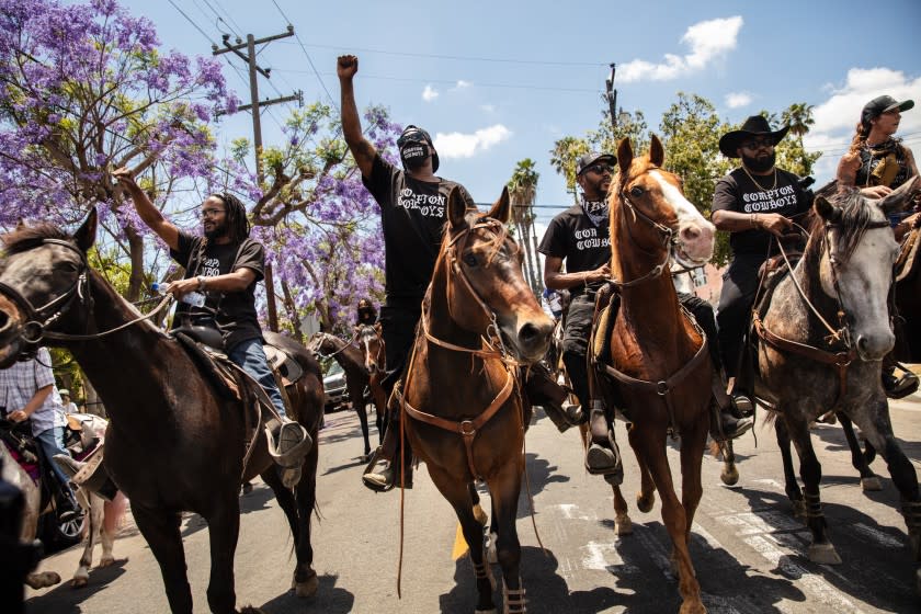 COMPTON, CA - JUNE 07: The Compton Cowboys ride down S Tamarind Ave, along with a couple thousand protesters, during the Compton, CA, Peace Ride, culminating at City Hall, on Sunday, June 7, 2020. (Jay L. Clendenin / Los Angeles Times)