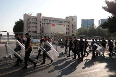 Turkish police walk in front of the Metropolitan Municipality headquarters in Diyarbakir
