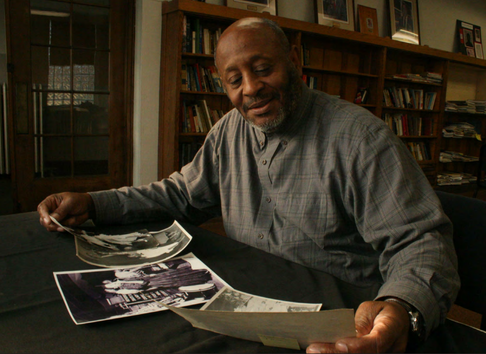 Founder of the Wisconsin Black Historical Society, Clayborn Benson, reviews photos in his office.