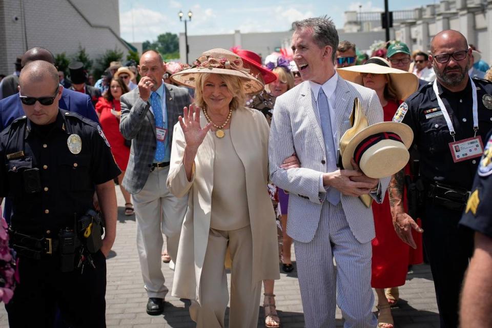 Martha Stewart is escorted through the crowds at Churchill Downs on Saturday.