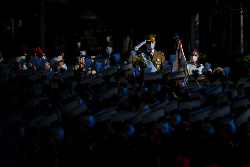 FILE - Spain's King Felipe salutes next to Queen Letizia during a military parade to celebrate a holiday known as 'Dia de la Hispanidad' or Hispanic Day in Madrid, Spain, Tuesday, Oct. 12, 2021. Spain’s Queen Letizia turned 50 on Thursday, Sept. 15, 2022. Spain is taking the opportunity to assess its scarred monarchy and ponder how the arrival of a middle-class commoner may help shake one of Europe’s most storied royal dynasties into a modern and more palatable institution. (AP Photo/Manu Fernandez, File)