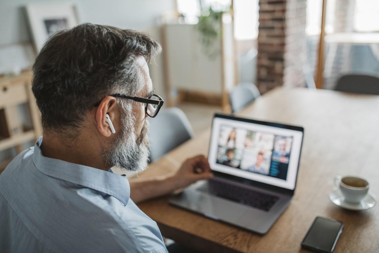 mature men at home during pandemic isolation have conference call