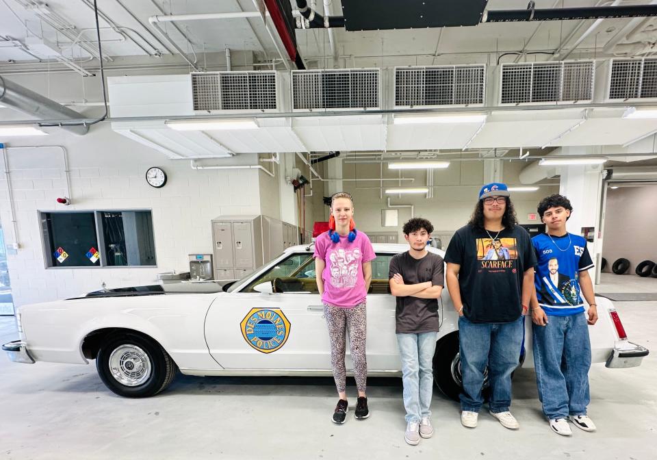 DMPS Central Campus seniors Natasha Harwell, Cristian Villa, Eric Shurvington and Inari Rivera pose with their replica of a 1978 DMPD squad car.