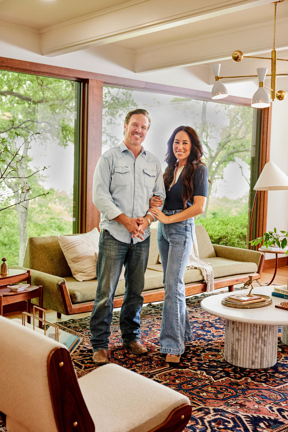 An antique rug grounds the living room, which boasts a floor-to-ceiling view of Lake Waco.