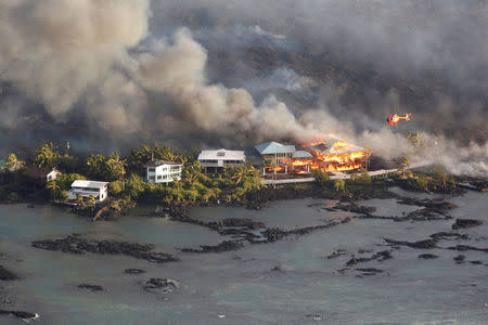 FILE PHOTO: Lava destroys homes in the Kapoho area, east of Pahoa, during ongoing eruptions of the Kilauea Volcano in Hawaii, U.S., June 5, 2018. REUTERS/Terray Sylvester/File Photo