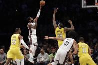 Brooklyn Nets' Kyrie Irving (11) shoots over Los Angeles Lakers' Dwight Howard (39) during the first half of an NBA basketball game Thursday, Jan. 23, 2020, in New York. (AP Photo/Frank Franklin II)