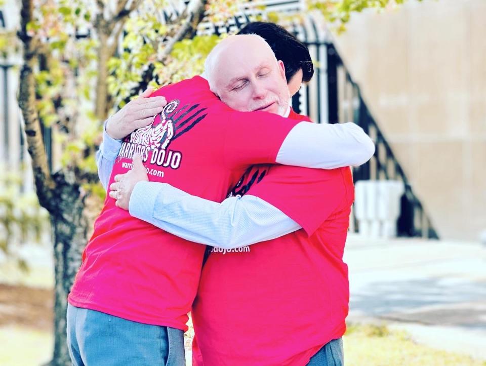 Edilberto Torres hugs his defense attorney, Brett Rosen, after he was acquitted on all charges related to accusations he sexually abused an 11-year-old student at his karate dojo.