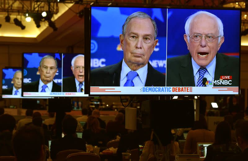 Former New York City Mayor Mike Bloomberg and Senator Bernie Sanders are seen on video screens in the media filing center during the ninth Democratic 2020 U.S. Presidential candidates debate at the Paris Theater in Las Vegas