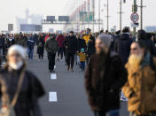 Protesters walk on the highway during protest in Belgrade, Serbia, Saturday, Dec. 4, 2021. Protesters blocked roads and bridges across Serbia to protest against new the amendments to the Law on Referendum and Expropriation. (AP Photo/Darko Vojinovic)